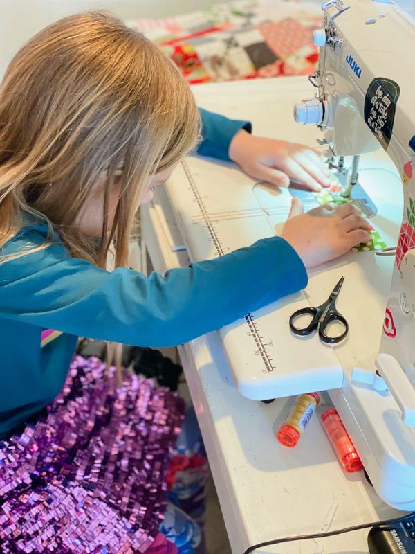 Lissa Alexander's granddaughter sewing in sequins